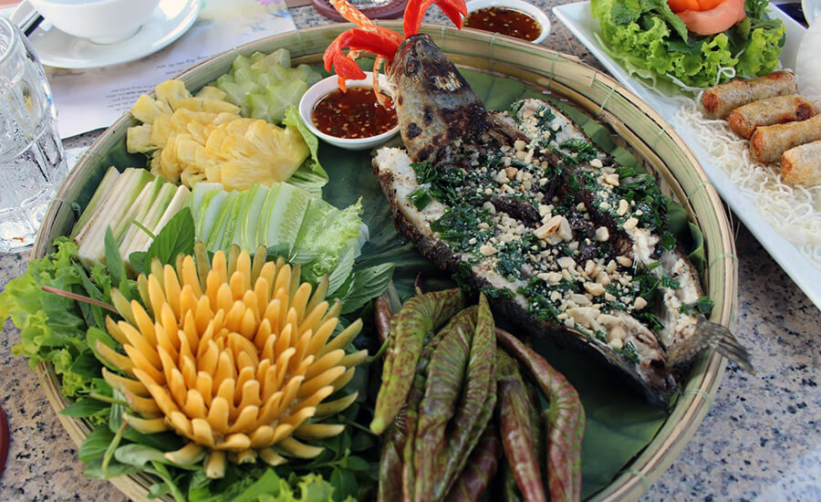 Grilled snakehead fish in young lotus leaves